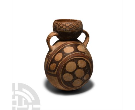 10th-15th century A.D. A bichrome ceramic flask composed of a bulbous body and hemispherical neck with inverted rim, flanked 