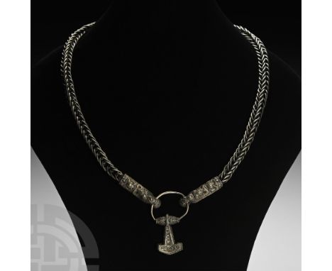 10th-11th century A.D. A substantial silver necklace comprising: an openwork trichinopoly chain with D-section beast-head ter