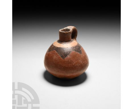 16th century A.D. or earlier. A carinated ceramic juglet with integral handle and polychrome geometric design to the shoulder