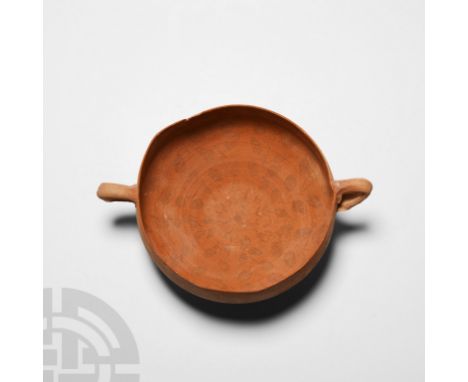 3rd-1st century B.C. A ceramic vessel with rounded base and carinated shoulder, thin rim with two moulded loop handles.  110 
