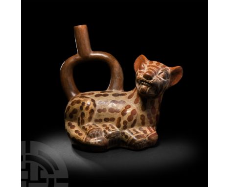 4th-7th century A.D. A bichrome ceramic stirrup bottle in the form of a spotted feline, likely a pampas cat, couchant and sna