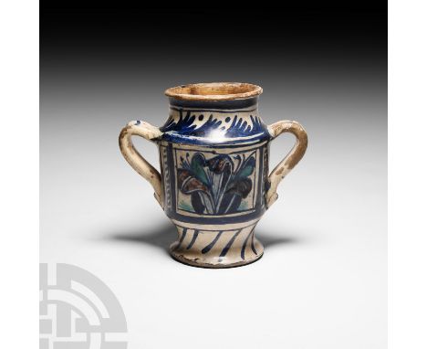 Italy, late 15th century A.D. A tin-glazed earthenware albarello featuring two handles and blue, green and manganese decorati
