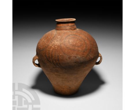 3rd millennium B.C. A piriform ceramic jar with tapering neck, everted rim and two loop handles to the equator; the upper bod
