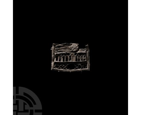 Circa 1380 A.D. A lead-alloy pilgrim's badge fragment, the lower portion of an image of the saint's shrine; the clothed body 