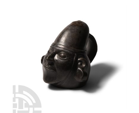 2nd-5th century A.D. A blackware ceramic vessel in the form of a male head wearing a conical cap and large, discoid ear ornam