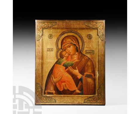 Circa 1860 A.D. A gilded and painted icon of the Virgin of Vladimir depicting nimbate Mary Theotokos with veiled head and wea