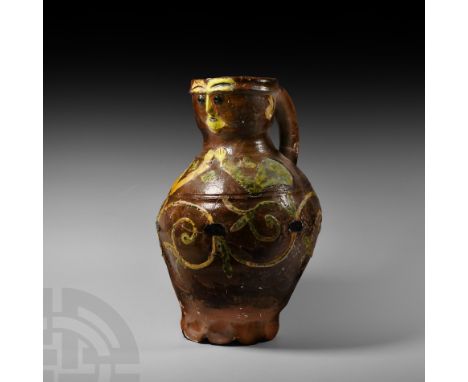 13th-14th century A.D. A polychrome glazed ceramic anthropomorphic jug, the body with a gentle biconical profile, socket styl