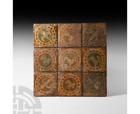 Flanders or Northern France, circa 1450-1500 A.D. A set of nine square glazed ceramic tiles arranged as a stag at centre of f