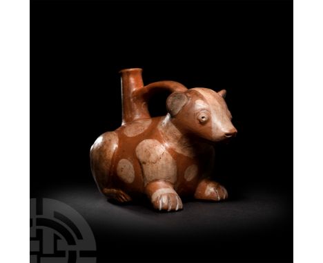 3rd-8th century A.D. A bichrome ceramic bottle in the form of a couchant animal, possibly a canine, with stylised facial and 
