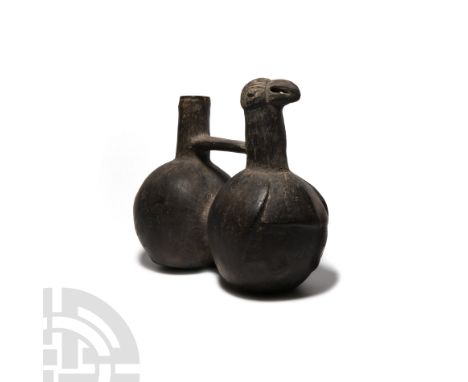10th-15th century A.D. A ceramic whistle vessel comprising two bulbous bodies with a waisted bridge between; plain cylindrica
