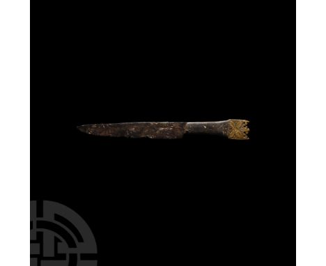 15th century A.D. A slender knife with single-edged iron blade, scale-tang hilt with original wooden scales; openwork trilobe