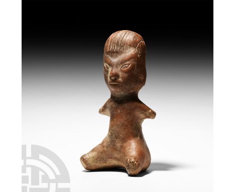 8th century B.C. or earlier. A large ceramic redware figure modelled seated with outstretched stub legs and arms, large head 