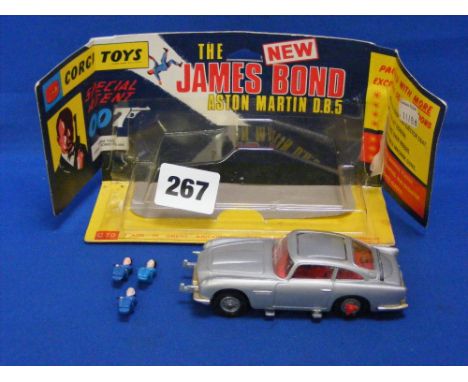 A Corgi 270 James Bond Aston Martin D.B.5. with original blister package, plus three extra figures.