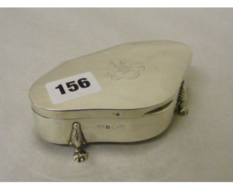 A silver trinket box of shaped form on four claw feet with monogram to lid, H/M Birmingham 1916, approx. 5 inches long.     