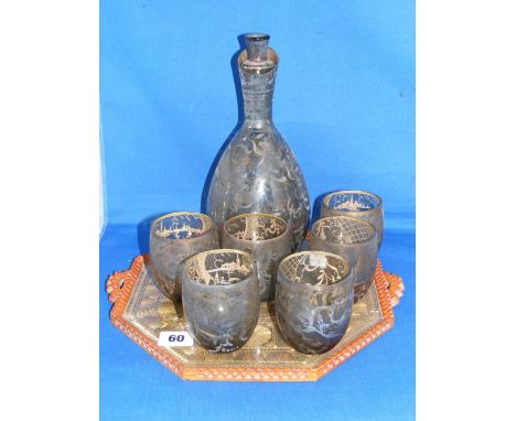 An antique glass drinks set comprising decanter and six tumblers, each having overlaid silvered designs of junks in a harbour