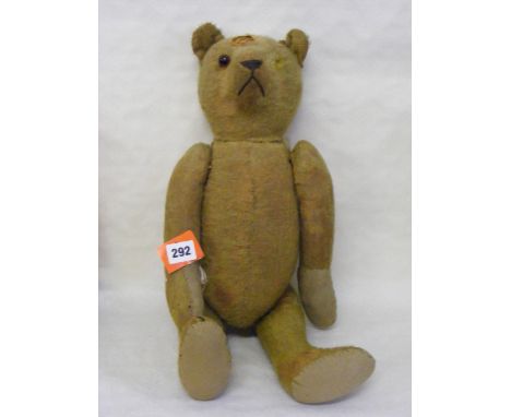A vintage teddy bear with jointed arms and legs, replacement pads and one glass eye, stitched nose, slight damage to head. Le