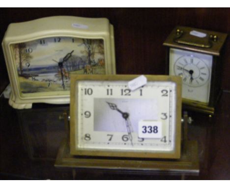 A circa 1950's mantel clock with hunting scene on dial, a musical alarm brass framed 1930's clock and heavy brass cased quart