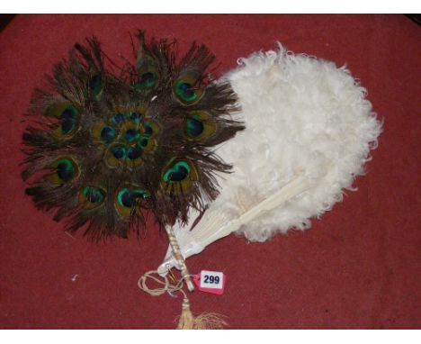 A vintage goose feather folding fan and a peacock feather fan on bound quill handle.