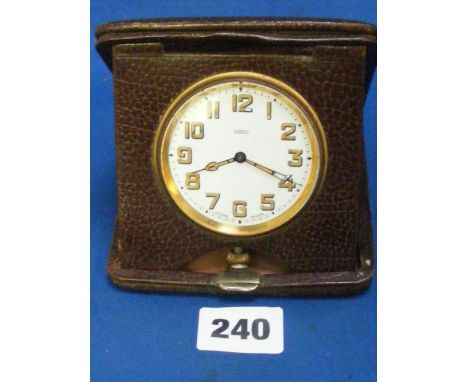 A leather cased 8 day travelling clock.