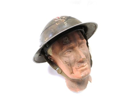 A WWII British Type II helmet with City of London Regiment badge and lettering L.B.L.F with display head 
