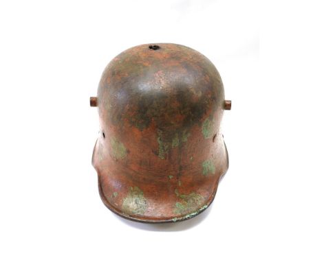 A German M1918 pattern helmet shell with camouflage design, impact to top of helmet