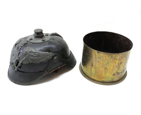 A 1917 shell case and German helmet / Pickelhaube design helmet 