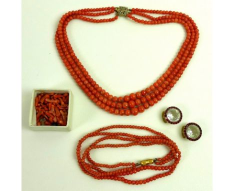 Two vintage coral necklaces, comprising a three strand necklace of graduated red coral beads and a two strand necklace of sim