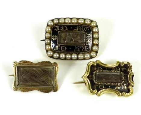 A group of three Georgian mourning brooches, comprising a rectangular brooch, with central panel enclosing a plaited lock of 