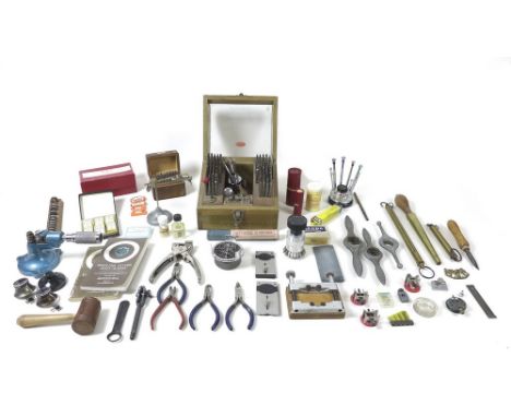 A box of assorted watchmakers tools, including Rolex / Oyster watch case opening tools, watch clamps, screwdrivers, a glazed 