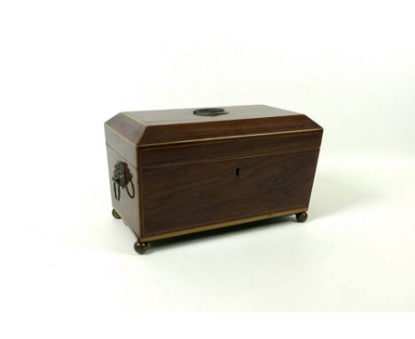 A Regency mahogany sarcophagus form tea caddy, containing wheel engraved Georgian glass mixing bowl between two compartments,