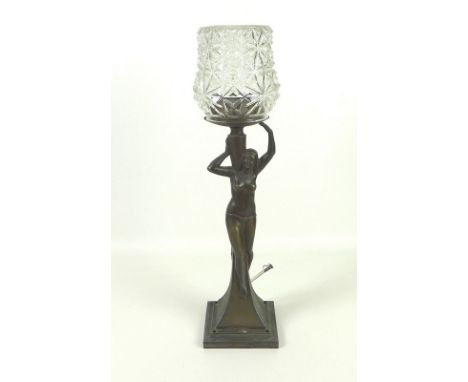 An Art Deco style figural table lamp formed as a nude lady holding an amphora on one shoulder, stepped square pedestal base, 