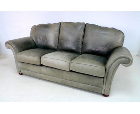 A modern green leather three seater sofa with button back, 210 by 97 by 100cm high.