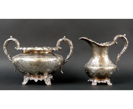 An early Victorian part tea set comprising a milk jug and a large double handled sucrier, each chased and embossed with rococ