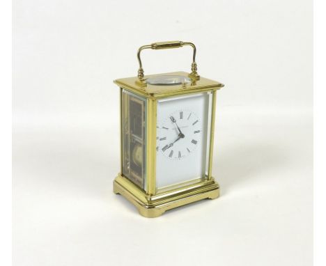 A 20th century carriage clock, the face with Roman numerals, conventional brass framed bevelled glass case, inscribed Matthew