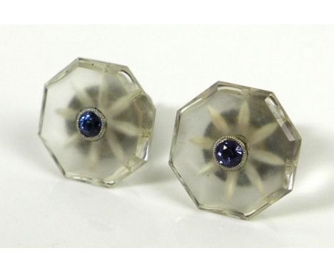 A pair of Art Deco rock crystal and sapphire ear studs, the octagonal rock crystal with central small cornflower blue sapphir