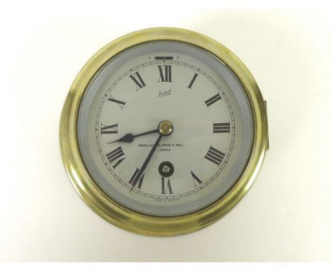 A Sestrel brass cased bulkhead clock with eight day movement, Imray, Laurie, Norie & Wilson, London, 16cm diameter.