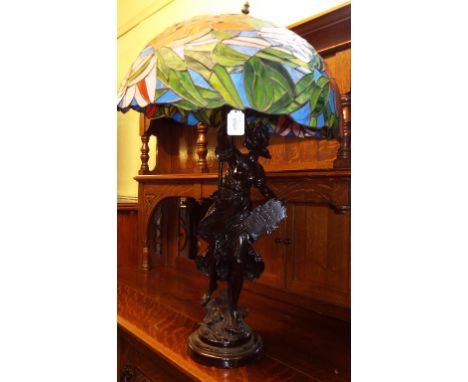 A spelter lamp, in the form of a lady sounding a horn, 83 cm high