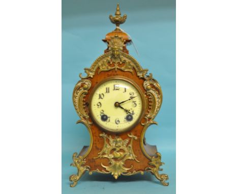 A mantel clock, the white dial with Arabic numerals, fitted a Lenzkirch two train movement, striking on a gong, in a kingwood