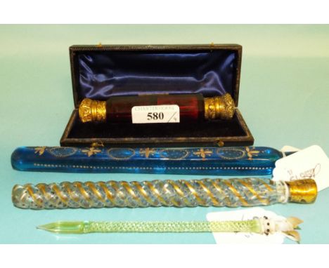 A ruby glass double ended scent bottle, with gilt metal mounts, 12.5 cm, cased, two other glass vials, and a pen (4)
