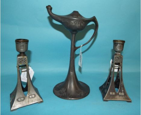 A pair of WMF pewter candlesticks, on square pierced spreading columns, with stylised decoration and four bracket feet, 15.5 