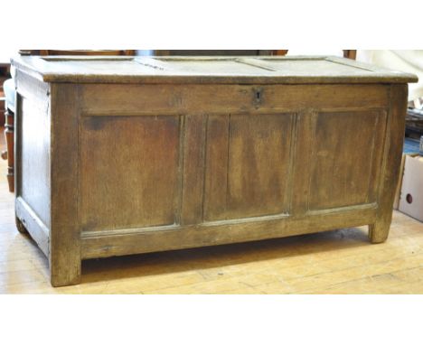 An early 18th century oak three panel coffer, on stile legs, 127 cm wide