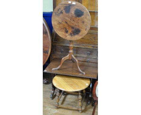 A 19th century mahogany tripod table, 53 cm diameter, two low tables, an armchair, and an oak cabinet with drawers (5) Condit