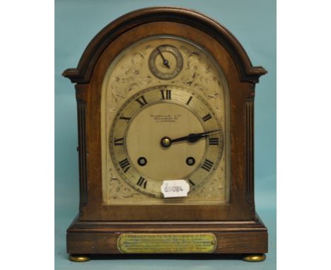 A mantel clock, the 13.5 cm dome top silvered dial signed RUSSELLS LTD, 18 CHURCH ST, LIVERPOOL, with Roman numerals and subs