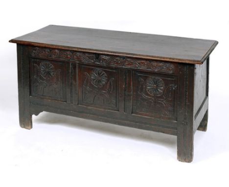 An oak coffer, the three panel front carved flowers, on stile legs, 136 cm wide  See illustration