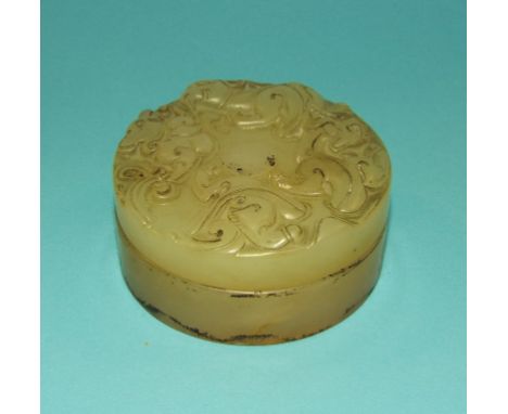 A Chinese jade box, with carved decoration, 6 cm diameter Condition report Report by RB

Generally good, small chip to other 