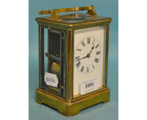 A carriage clock, the 6.5 cm wide enamel dial with Roman numerals, fitted an eight day movement, striking on a gong, in a bra