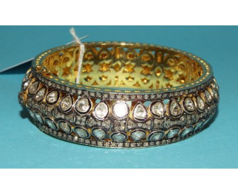 A 14ct gold bangle, set old cut diamonds