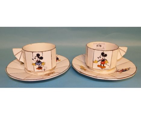 A pair of French pottery Walt Disney Mickey Mouse cups and saucers