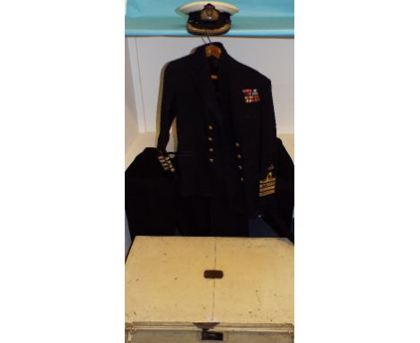 A painted tin trunk, Capt A Roberts Berks RHA, a Fleet Air Arm Officers jacket, two pairs of trousers and cap