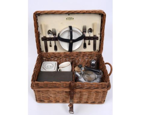 A 1920s Sirram two person picnic set, with a kettle and burner, a metal sandwich tin, a wicker covered milk bottle and other 